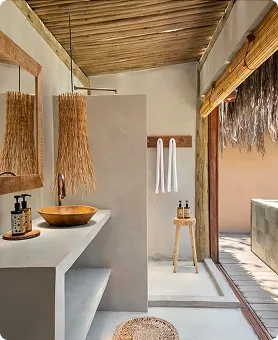 Tropical stone bathroom surrounded by greenery